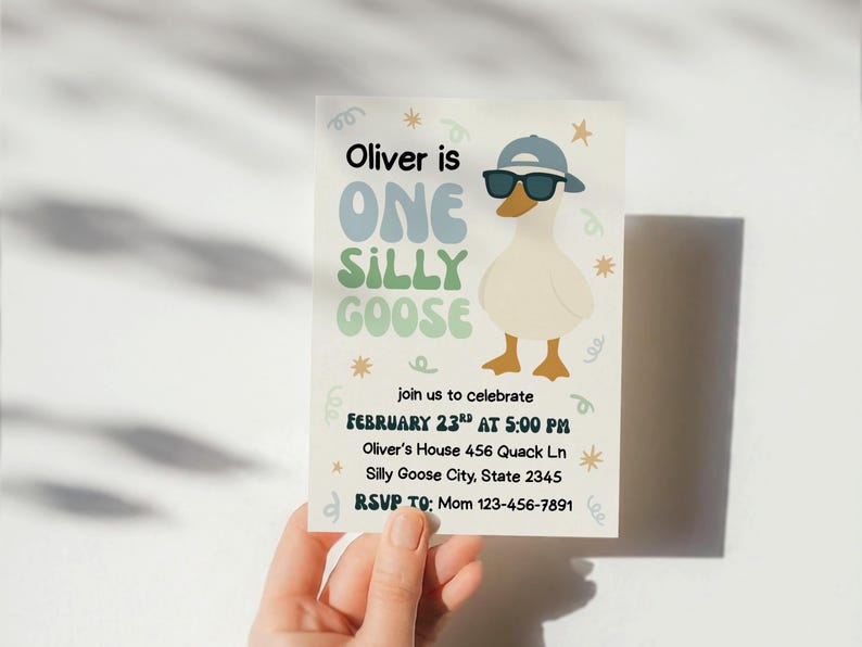 May include: A birthday invitation featuring a cartoon goose wearing sunglasses and a cap. The text reads "Oliver is One Silly Goose" with event details. The invitation is held by a hand.