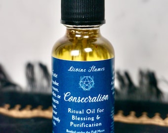 May include: A glass bottle of Consecration ritual oil with a black dropper. The blue label features white text: "Divine Flames" and "Consecration Ritual Oil for Blessing & Purification." The bottle contains 29.57 ml of oil.