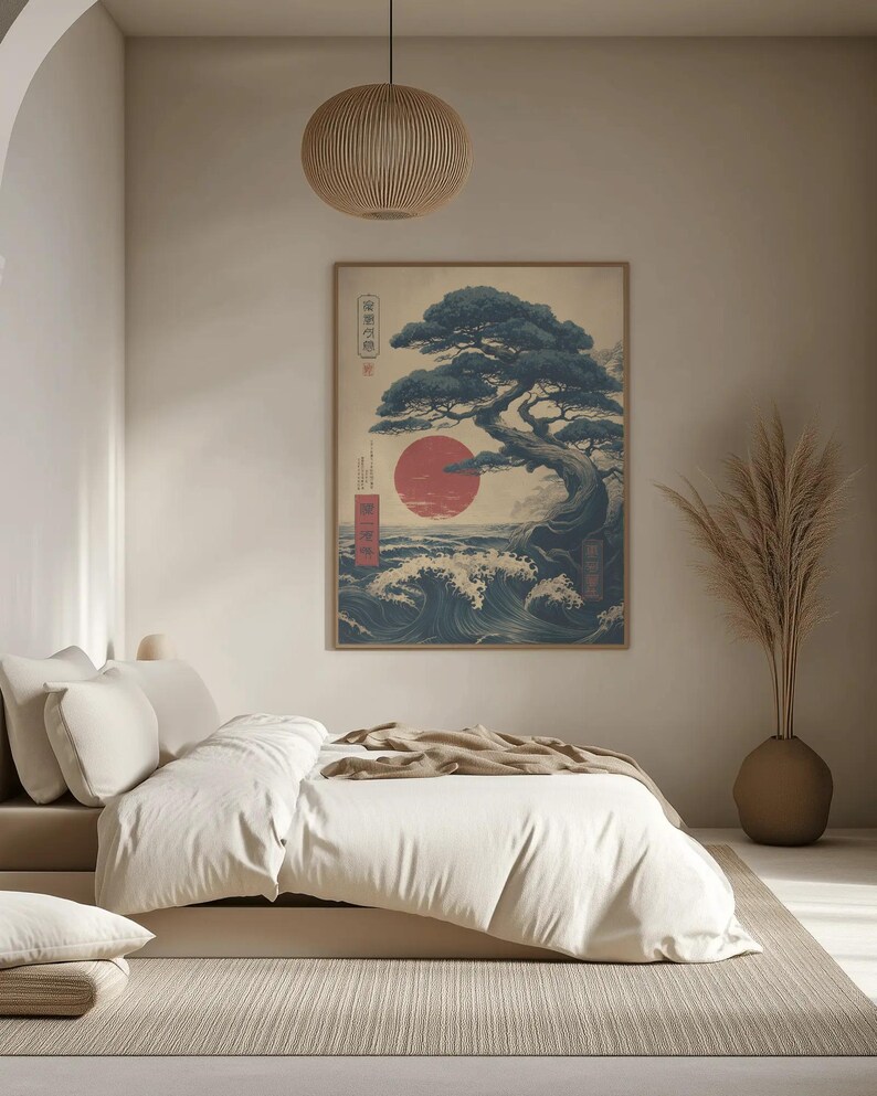 May include: A framed Japanese art print featuring a bonsai tree, a red sun, and ocean waves. The artwork is displayed in a bedroom, above a bed with white bedding. The room has a neutral colour scheme with a beige rug and a decorative vase.