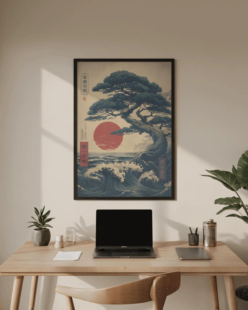 May include: Framed art print with a Japanese landscape design. The artwork shows a bonsai tree, a red sun, and ocean waves in blue and white. The print includes Japanese text and is displayed on a wooden desk.