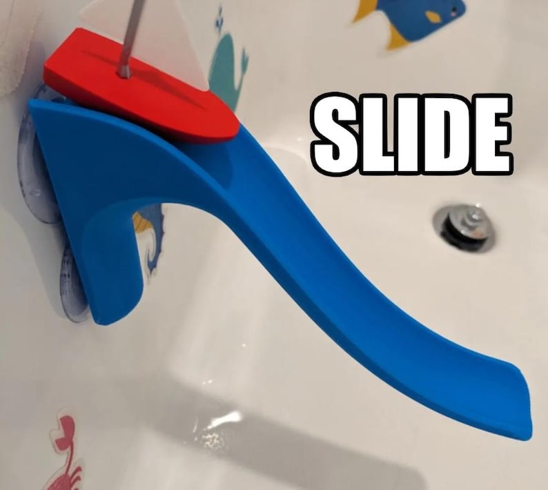 May include: A blue and red plastic bath toy slide with the word "SLIDE" in large white letters. The slide is attached to the side of a bathtub with suction cups. A red boat-shaped piece sits at the top of the slide.