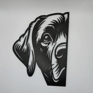 May include: Black metal wall art depicting the head of a dog, featuring detailed lines and a cutout design. The dog's eye, nose, and ear are visible, creating a striking silhouette. The artwork is set against a white background.