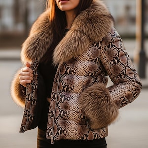 May include: A snakeskin-effect jacket with a fur collar and cuffs. The jacket has a brown and tan snakeskin pattern, a large fur collar, and fur cuffs. The jacket is zipped up and has a sleek, modern design.