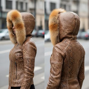 May include: A brown snakeskin-patterned leather jacket with a fur-trimmed hood. The jacket features a zip closure. The fur trim is a light brown colour. The jacket is worn by a person.