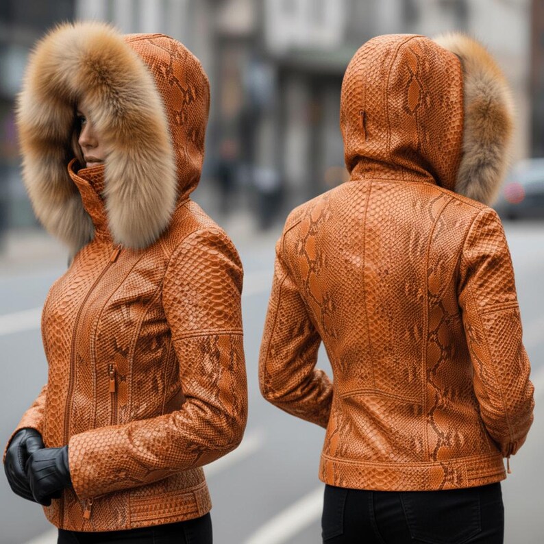 May include: A brown and tan snakeskin-effect leather jacket with a fur-trimmed hood. The jacket has a zip closure and is worn with black gloves. The image shows the front and back of the jacket, showcasing the textured pattern.