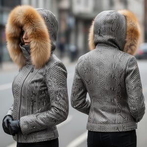 May include: A grey faux snakeskin jacket with a fur-lined hood. The jacket has a zip closure and black gloves. The hood features a brown fur trim. The jacket is shown from the front and back.