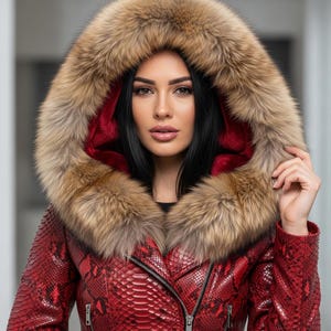 May include: A red snakeskin-textured jacket with a fur-lined hood. The hood features a brown fur trim and a red interior. The jacket has a zipper closure and a fitted silhouette, offering a luxurious and stylish outerwear option.