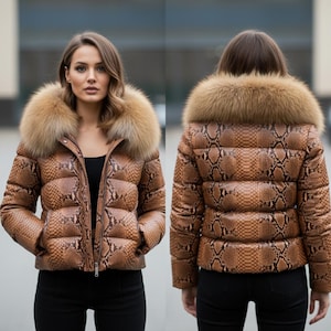 May include: A brown snakeskin-patterned puffer jacket with a large fur collar. The jacket features a zip closure and pockets. The model is wearing black trousers. A fashionable outerwear item.