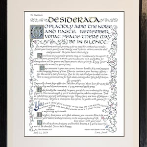 May include: Framed print of the poem "Desiderata" with ornate calligraphy and floral embellishments. The text is in black ink on a cream-colored background, framed in a black wooden frame. The date "July 22, 2014" is visible.