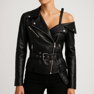 May include: Black leather jacket with an asymmetrical design. The jacket features a notched collar, an off-the-shoulder strap, and a belted waist. It has silver zippers and hardware. The jacket is a stylish outerwear piece.