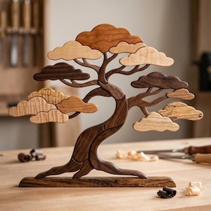 May include: A set of three ceramic mugs with a speckled, matte finish. The mugs are in shades of cream, light gray, and dark gray. Each mug has a simple, minimalist design, perfect for coffee or tea.