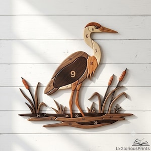 May include: A wooden wall art piece shaped like a heron standing among cattails, constructed from various wood tones. The bird and base are composed of interlocking segments, each labeled with a number, including 4, 5, 6, 7, 8, 9, 10, 11, 12, 14, 17, 20, 31, 34, 35, 36, 37, 38, 39, and 40.