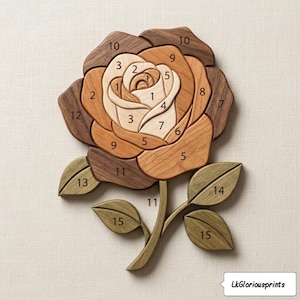 May include: A wooden rose sculpture with numbered petals and leaves. The rose is crafted from various shades of wood, including light beige, brown, and dark brown. The leaves are green. The sculpture is on a neutral background. The text "LkGloriousprints" is in the bottom right corner.
