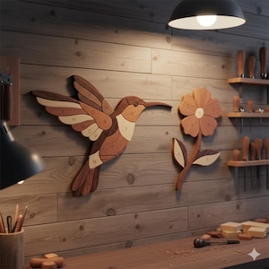 May include: Wooden hummingbird and flower wall art. The hummingbird is made of various wood tones and has lettered segments. The flower has a brown center and petals, with a light brown stem and leaves. The art is mounted on a wood-paneled wall.