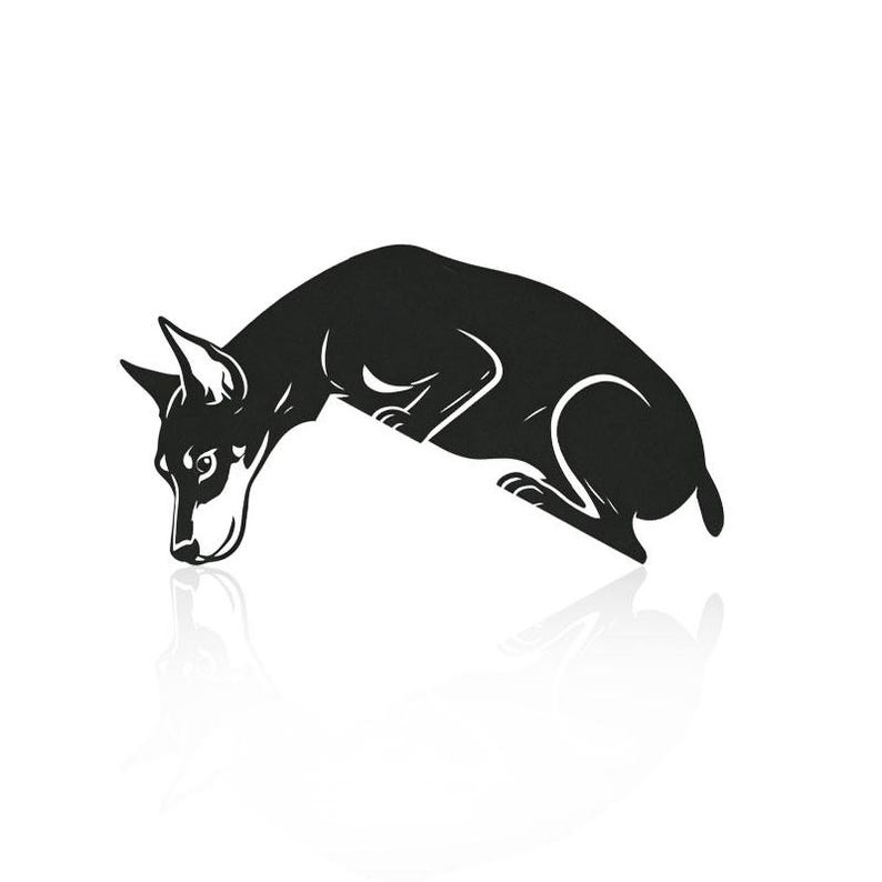 May include: A black silhouette graphic of a dog in a crouching position with its head lowered toward the ground. The design features sharp, clean lines and a solid black fill, creating a high-contrast visual representation of a canine.