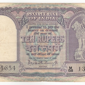 Könnte beinhalten: Indische Zehn-Rupien-Banknote. Die Banknote zeigt Text in Englisch und Hindi, das Siegel der Reserve Bank of India und das Ashoka-Säulen-Emblem. Die Seriennummer lautet 135654.