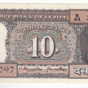 May include: A ten rupee banknote from the Reserve Bank of India. The note displays the number 10, with text in English and Hindi. The note includes a serial number and the emblem of India.