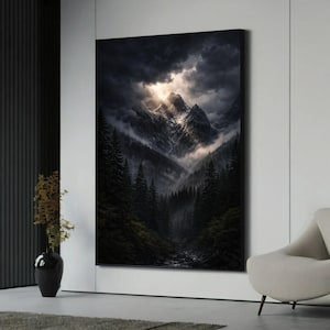 May include: A large canvas print depicts a dramatic mountain landscape. Dark, ominous clouds part to reveal sunlight illuminating snow-capped peaks. A dense forest fills the valley below, with a river winding through it. The artwork is displayed in a modern living space.