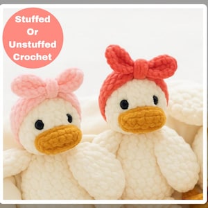 May include: Two handmade crochet duck toys. One duck has a pink bow and the other has a red bow. Both ducks have black eyes and yellow beaks. The text in the image says "Stuffed Or Unstuffed Crochet".