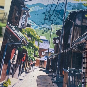 May include: A spiral-bound sketchbook page featuring a detailed marker illustration of a narrow Japanese street. The scene depicts traditional wooden buildings, hanging red lanterns, vertical signage with Japanese text, and power lines.