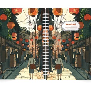 May include: Spiral-bound notebook featuring a detailed illustration of a Japanese street scene. The artwork depicts a person walking down a lantern-lined street. The notebook cover has the word "Notebook" in a decorative label.