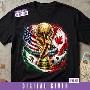 May include: A black t-shirt featuring a graphic of the gold FIFA World Cup trophy, a soccer ball, and the flags of the United States, Canada, and Mexico. The trophy base includes the text FIFA WORLD CUP MEXICO 2026. A digital watermark is present.