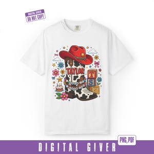 May include: A white t-shirt featuring a graphic of a red cowboy hat atop a cow-print cowboy boot. The boot displays the text TAYLOR and a beaded bracelet reading I KNEW IT I KNEW YOU. Surrounding elements include colorful flowers, stars, a cake, and blocks with the letters T, S, and the number 5.