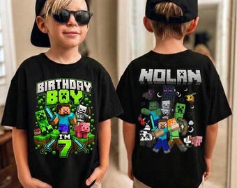 May include: A black t-shirt featuring a Minecraft-themed graphic. The front displays the text "BIRTHDAY BOY I'M 7" with game characters. The back shows the name "NOLAN" above a collection of various Minecraft characters and creatures.