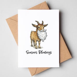 Könnte beinhalten: Eine Grußkarte mit einer Cartoon-Ziege mit weißem Bart und dem Text "Seasons Pleatings". Die Karte befindet sich auf weißem Hintergrund mit einem braunen Umschlag dahinter. Die Ziege ist braun mit schwarzen Hörnern.