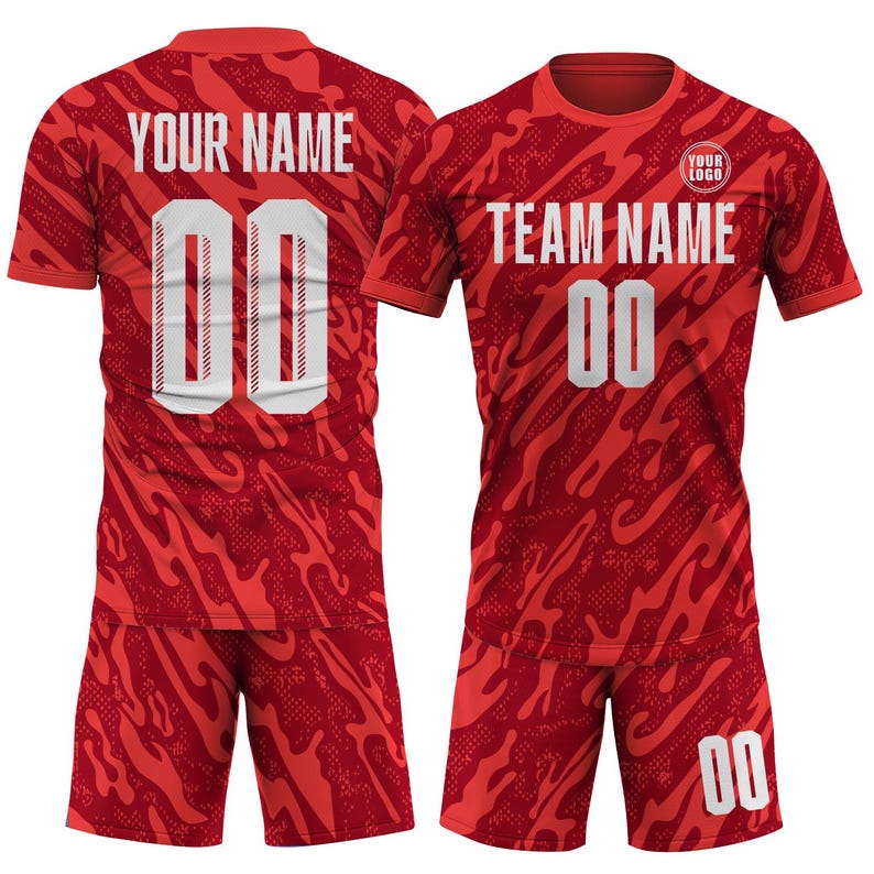 May include: Red athletic uniform set with a camouflage-like pattern. The jersey and shorts feature the number "00" in white. The jersey has the text "YOUR NAME" and "TEAM NAME" in white. A small logo is visible on the jersey.