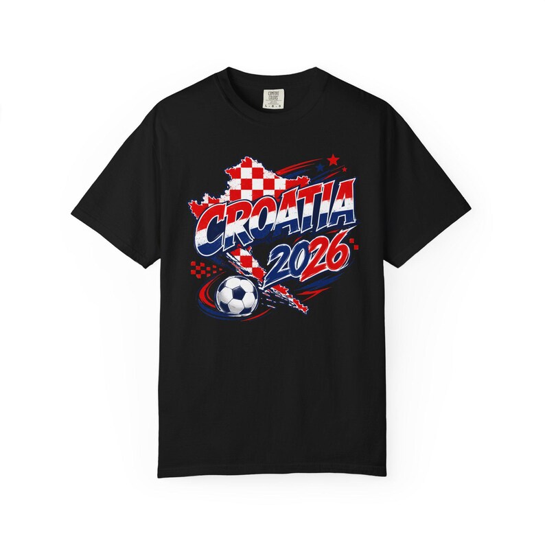 May include: Black t-shirt featuring a graphic design with the word "CROATIA" in red and blue, the year "2026", a soccer ball, and a map of Croatia in red and white checkered pattern. The design is centered on the front of the shirt.