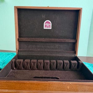 May include: A set of three ceramic mugs with a speckled, matte finish. The mugs are in shades of cream, light gray, and dark gray. Each mug has a simple, minimalist design, perfect for coffee or tea.