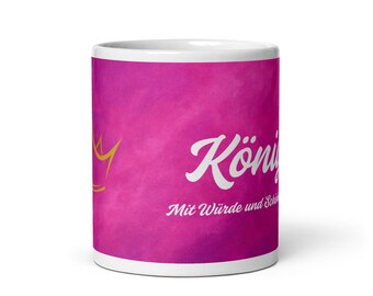May include: A white ceramic mug with a vibrant pink background. The mug features a gold crown graphic and the word "König" in white script, along with additional text. A stylish and decorative item.