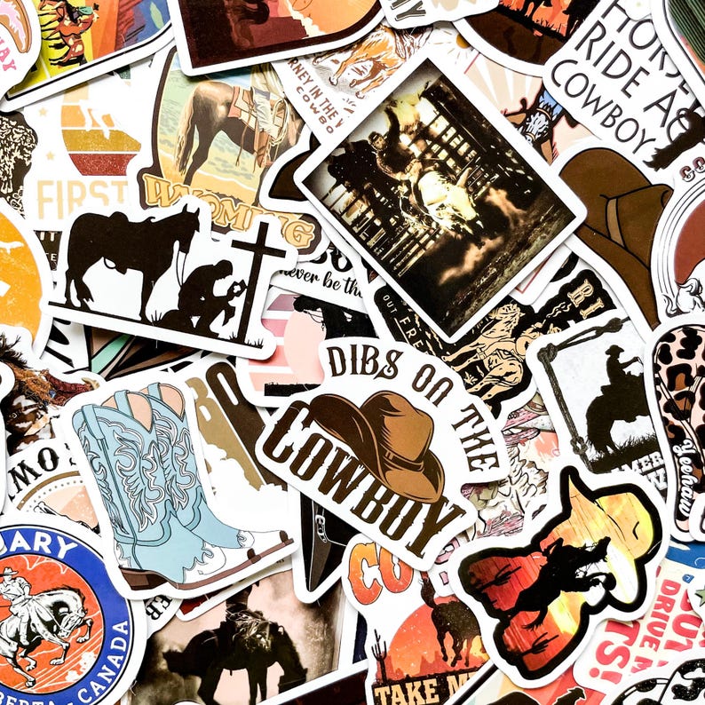 May include: A collection of cowboy-themed stickers featuring images of horses, cowboy hats, and rodeo scenes. The stickers have various colors, including brown, blue, and orange, with text like "Cowboy" and "Dibs on the Cowboy".