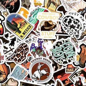 May include: A collection of colorful cowboy-themed stickers. Designs include cowboy hats, cacti, rodeo riders, and the text "N. Mexico", "Cowboy Stuff", and "Cowboy Rodeo". The stickers feature a variety of colors and styles, perfect for decorating.