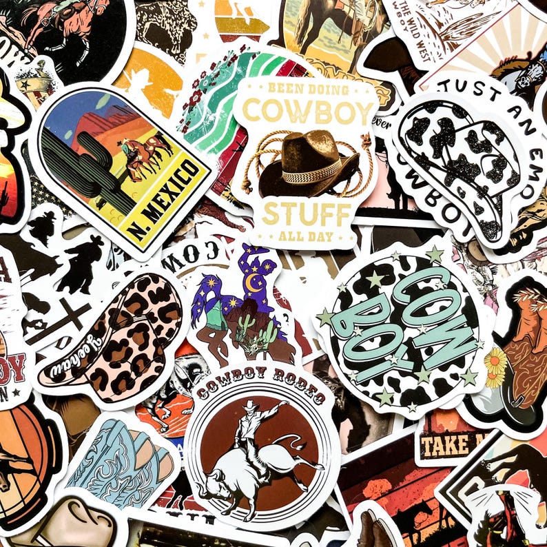 May include: A collection of colorful cowboy-themed stickers. Designs include cowboy hats, cacti, rodeo riders, and the text "N. Mexico", "Cowboy Stuff", and "Cowboy Rodeo". The stickers feature a variety of colors and styles, perfect for decorating.