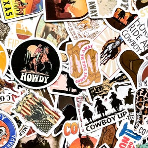 May include: A collection of cowboy-themed stickers with various designs. The stickers feature images of cowboys, horses, boots, and the American flag. Some stickers have text like "Howdy" and "Cowboy Take Me Away."