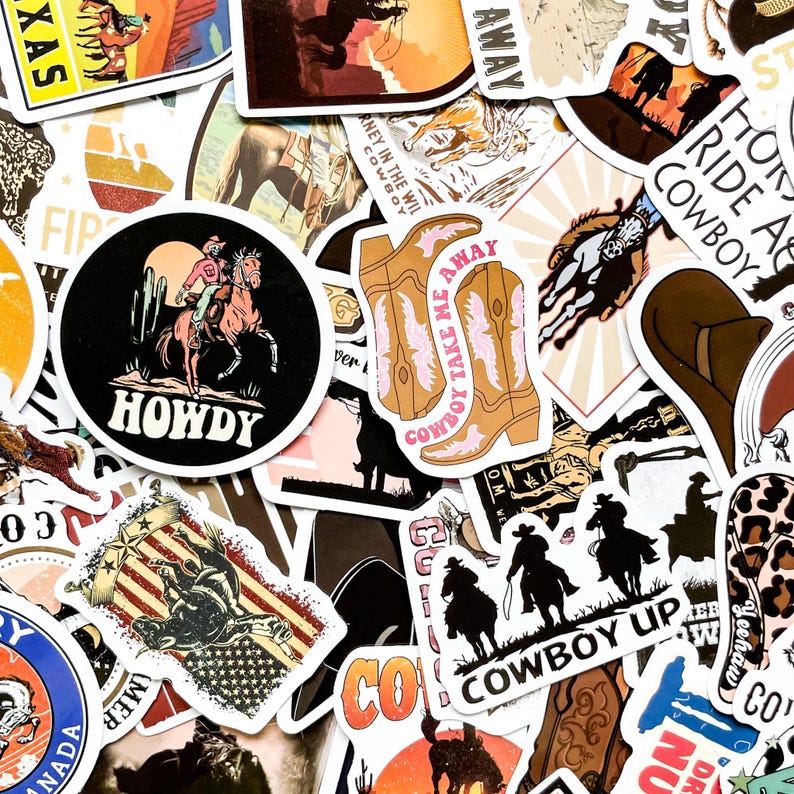 May include: A collection of cowboy-themed stickers with various designs. The stickers feature images of cowboys, horses, boots, and the American flag. Some stickers have text like "Howdy" and "Cowboy Take Me Away."
