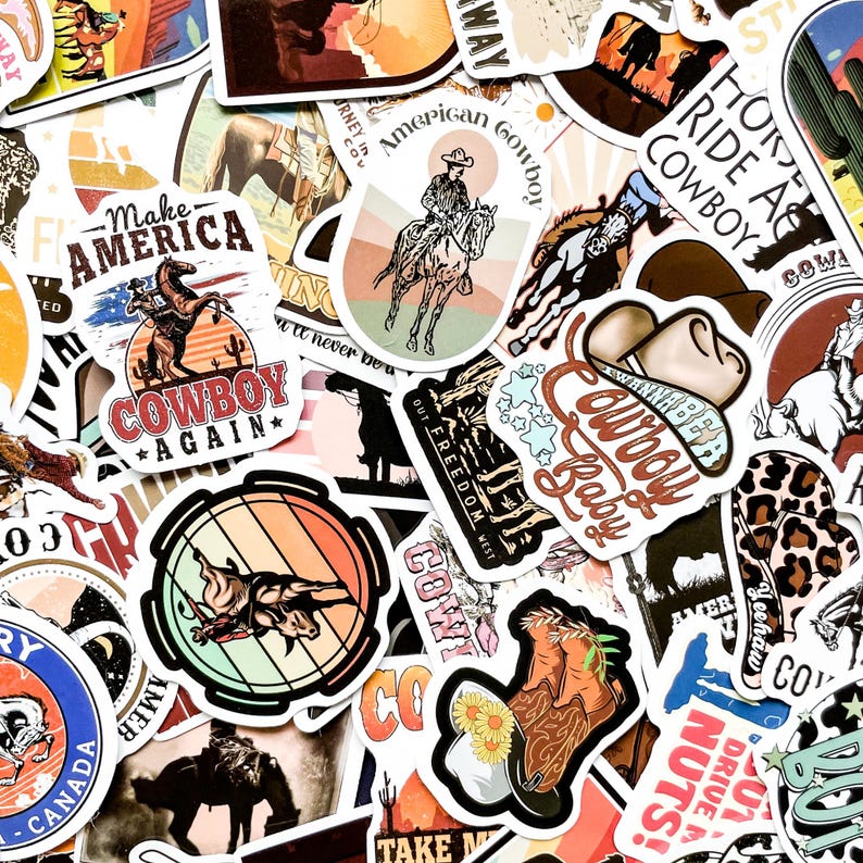 May include: A collection of colorful cowboy-themed stickers. Designs include cowboys on horses, cowboy hats, and phrases like "Cowboy Baby" and "Make America Cowboy Again." The stickers feature a variety of colors and styles.