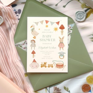 May include: A baby shower invitation with a whimsical design featuring a duck, bunny, and other illustrations. The invitation is inside a green envelope, with the text "PLEASE JOIN US FOR A BABY SHOWER IN HONOR OF Elizabeth Wilson".