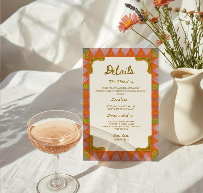 May include: A wedding details card with a decorative border and the word "Details" in script. A glass of champagne is in front of the card, and a vase of flowers is in the background.