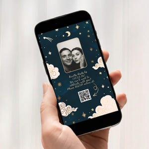 May include: A smartphone screen shows a wedding invitation with a couple's photo. The design features a dark blue background with gold stars, clouds, and a crescent moon. The text includes RSVP information and a QR code.