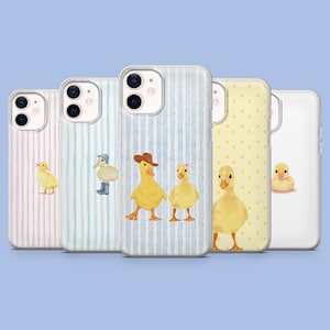 May include: A collection of five phone cases with duckling designs. The cases feature various patterns, including pink stripes, blue stripes, yellow polka dots, and a solid white case. Each case showcases a different watercolor illustration of a duckling.