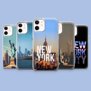 May include: A collection of five phone cases featuring iconic New York City landmarks. The cases display images of the Statue of Liberty, the Manhattan skyline, and the Empire State Building, with the words "NEW YORK" on one case.