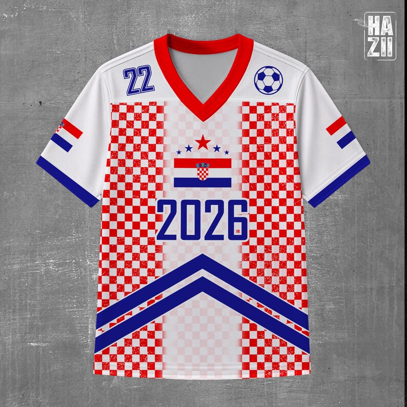 May include: A white V-neck jersey featuring a red and white checkered pattern on the sides, blue chevron stripes at the bottom, the number 22, the year 2026, a soccer ball icon, and a central graphic of the Croatian flag with stars above it.