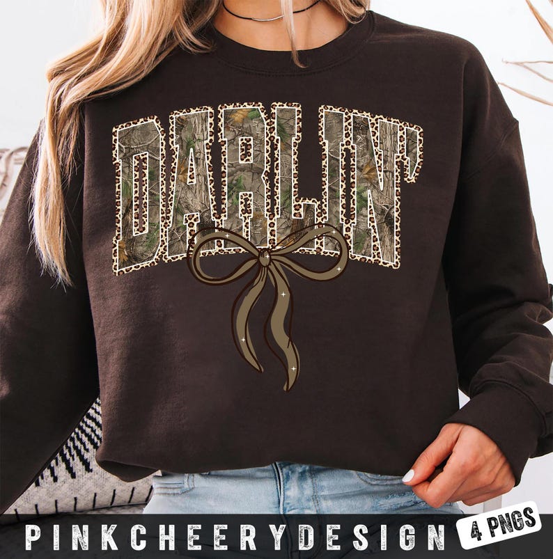 May include: A dark brown sweatshirt with the word "DARLIN" in a camouflage and leopard print design. A brown bow with glitter accents is below the text. The text "PINKCHEERYDESIGN 4 PNGS" is at the bottom.