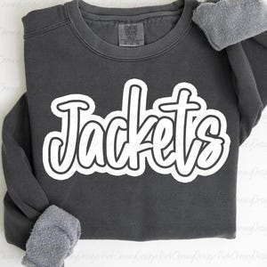 May include: A dark gray sweatshirt with the word "Jackets" in large, white, cursive lettering. The sweatshirt has a crew neck and long sleeves with a gray, fuzzy lining visible at the cuffs. The Comfort Colors tag is visible.