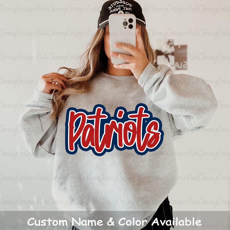 May include: A light gray sweatshirt with the word "Patriots" in red script with a blue outline. The text "Custom Name & Color Available" is at the bottom of the image.
