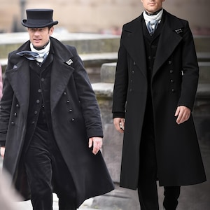 May include: Two people in black overcoats. One wears a black top hat, white scarf, and black waistcoat. The other wears a black waistcoat and white scarf. Both are in black trousers.