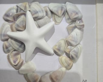 Sea Glass Framed picture. Oyster shells in the shape of a heart with star fish